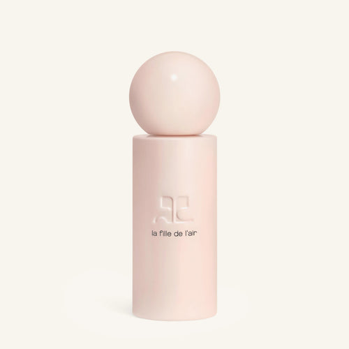 Courrèges La Fille de l’air bottle with a large pink sphere on top on a pink pedestal against a cream background