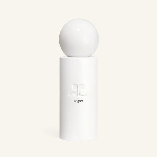 Courrèges Slogan perfume bottle with a large white sphere cap on a white pedestal against a pale background