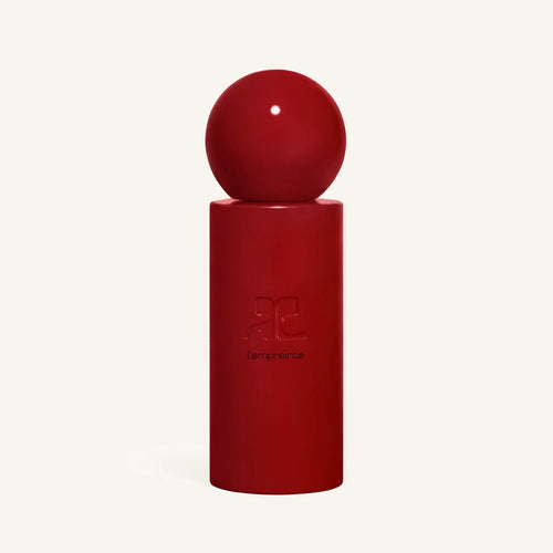 Courrèges L empreinte red perfume bottle with a spherical cap atop a red cylinder against a pale background