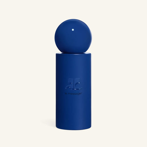 Courrèges Le Messager perfume bottle with a blue spherical cap perched on a matching blue pedestal against a pale background