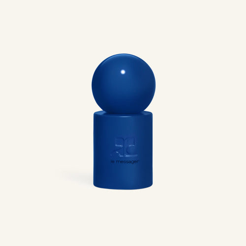Blue sphere over a cobalt perfume bottle against a pale background, Courrèges Le Messager