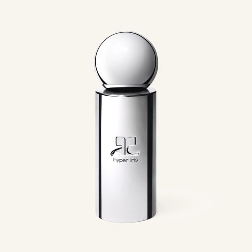 Courrèges Hyper Iris perfume bottle with a large chrome cap against a pale background